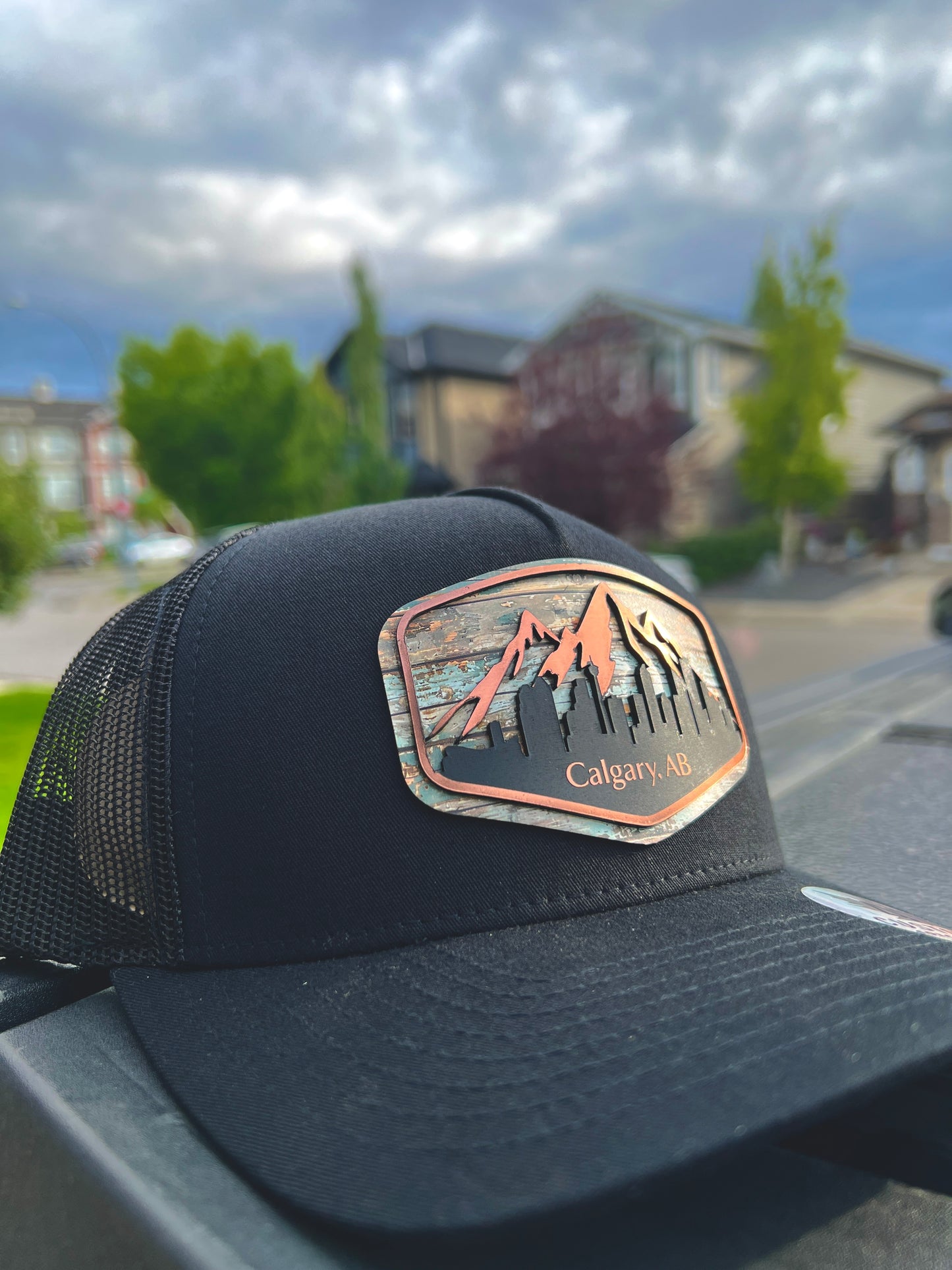 Calgary Skyline trucker cap featuring adjustable snapback, breathable mesh, structured front, and detailed city skyline embroidery, handcrafted in Canada