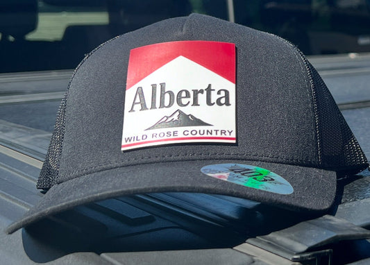 Alberta Wild Rose Country trucker hat with laser-engraved acrylic patch, handcrafted in Canada, breathable mesh back, adjustable snapback