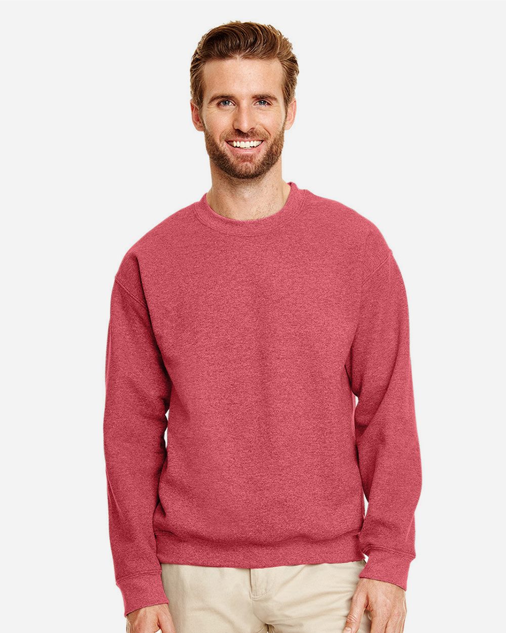 Model wearing a Gildan 18000 Heavy Blend crewneck sweatshirt in Heather Scarlet Red, front lifestyle view.