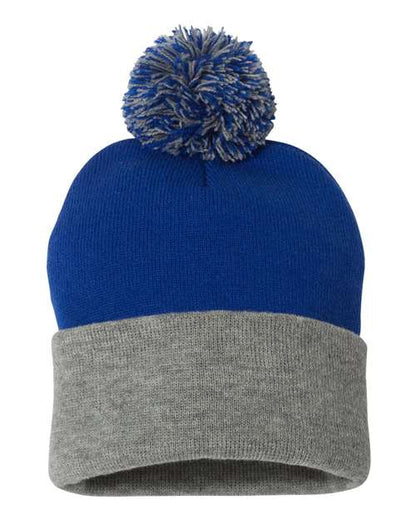 Two-toned blue and gray beanie with a pom-pom on a white background