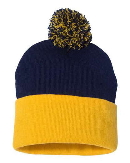 Navy and yellow beanie with pom-pom on a white background