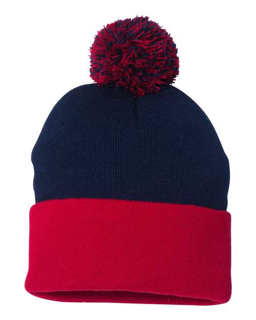 Two-tone navy and red beanie with a pom-pom on a white background