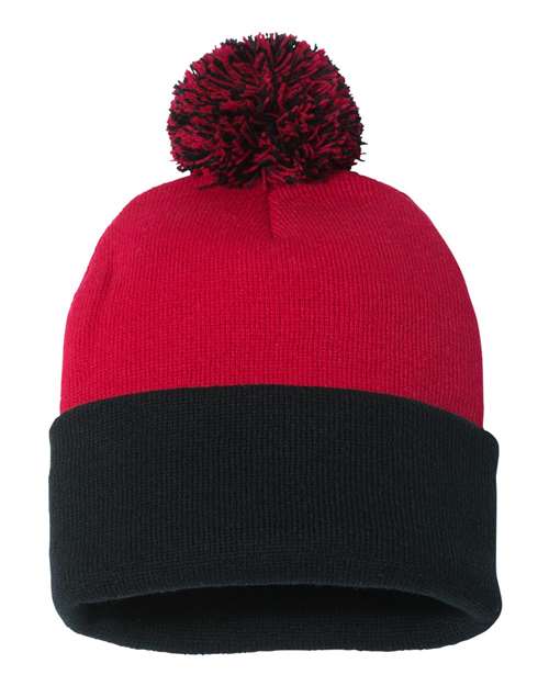 Red and black beanie with a pom-pom on a white background