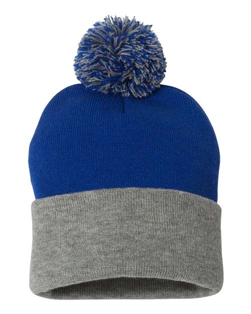 Two-toned blue and gray beanie with a pom-pom on a white background