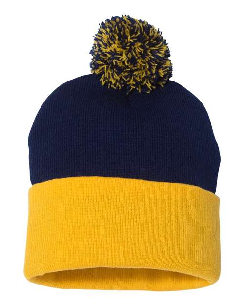 Navy and yellow beanie with pom-pom on a white background