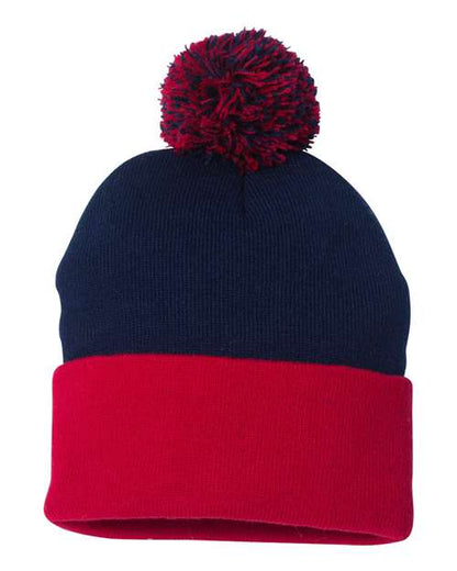 Two-tone navy and red beanie with a pom-pom on a white background