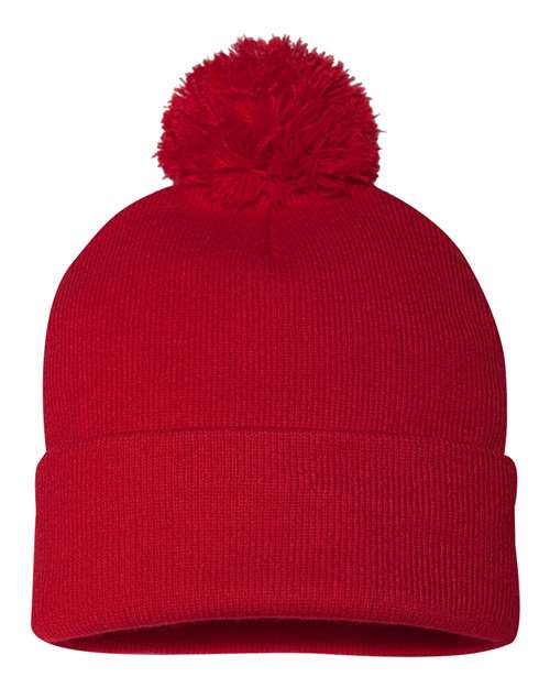 Red knit beanie with a pom-pom on a white background