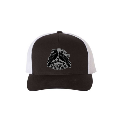 Attempted Murder 5-panel trucker hat in black with white mesh, front product mockup showing a grey crow design patch.