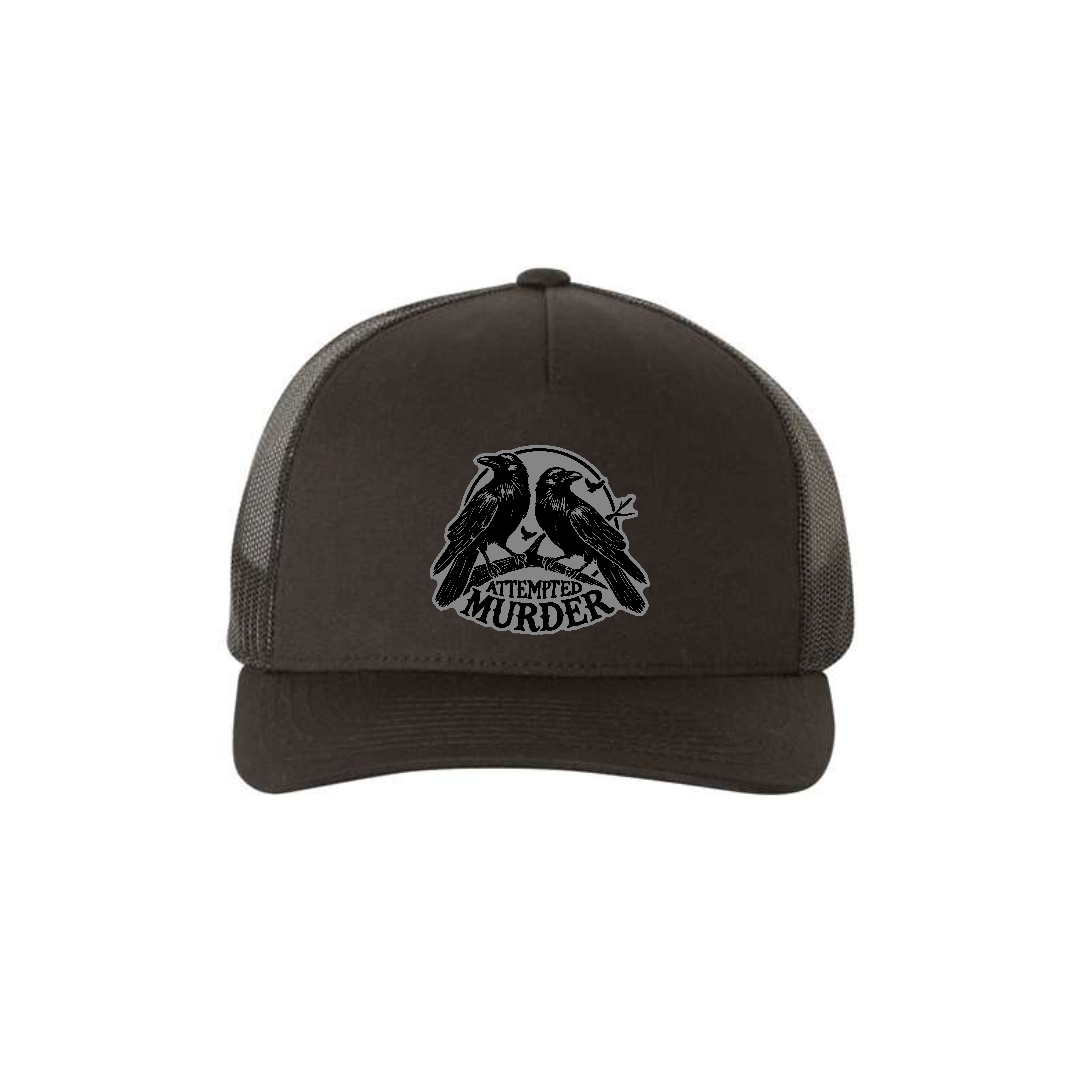 Attempted Murder 5-panel trucker hat in black, front product mockup showing a grey crow design patch.