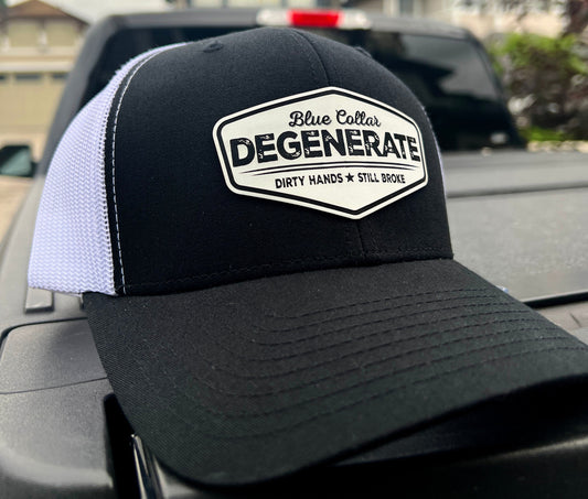 Black and white Blue Collar Degenerate trucker hat with a white slogan patch, angled front view.