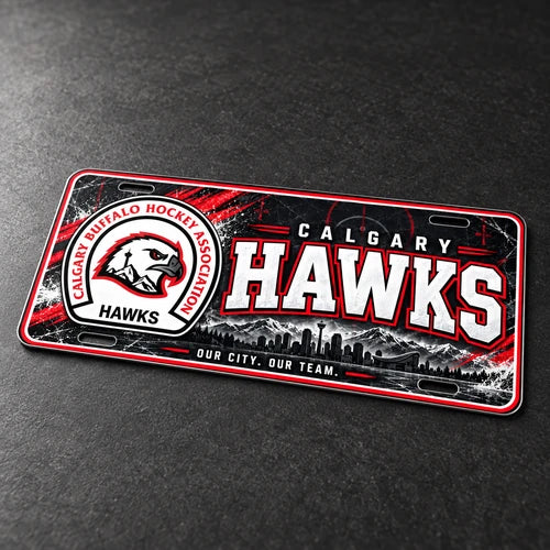Mockup of the Calgary Hawks novelty license plate lying at an angle on a dark surface, showing its thin aluminum edge