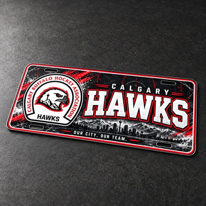 Mockup of the Calgary Hawks novelty license plate lying at an angle on a dark surface, showing its thin aluminum edge