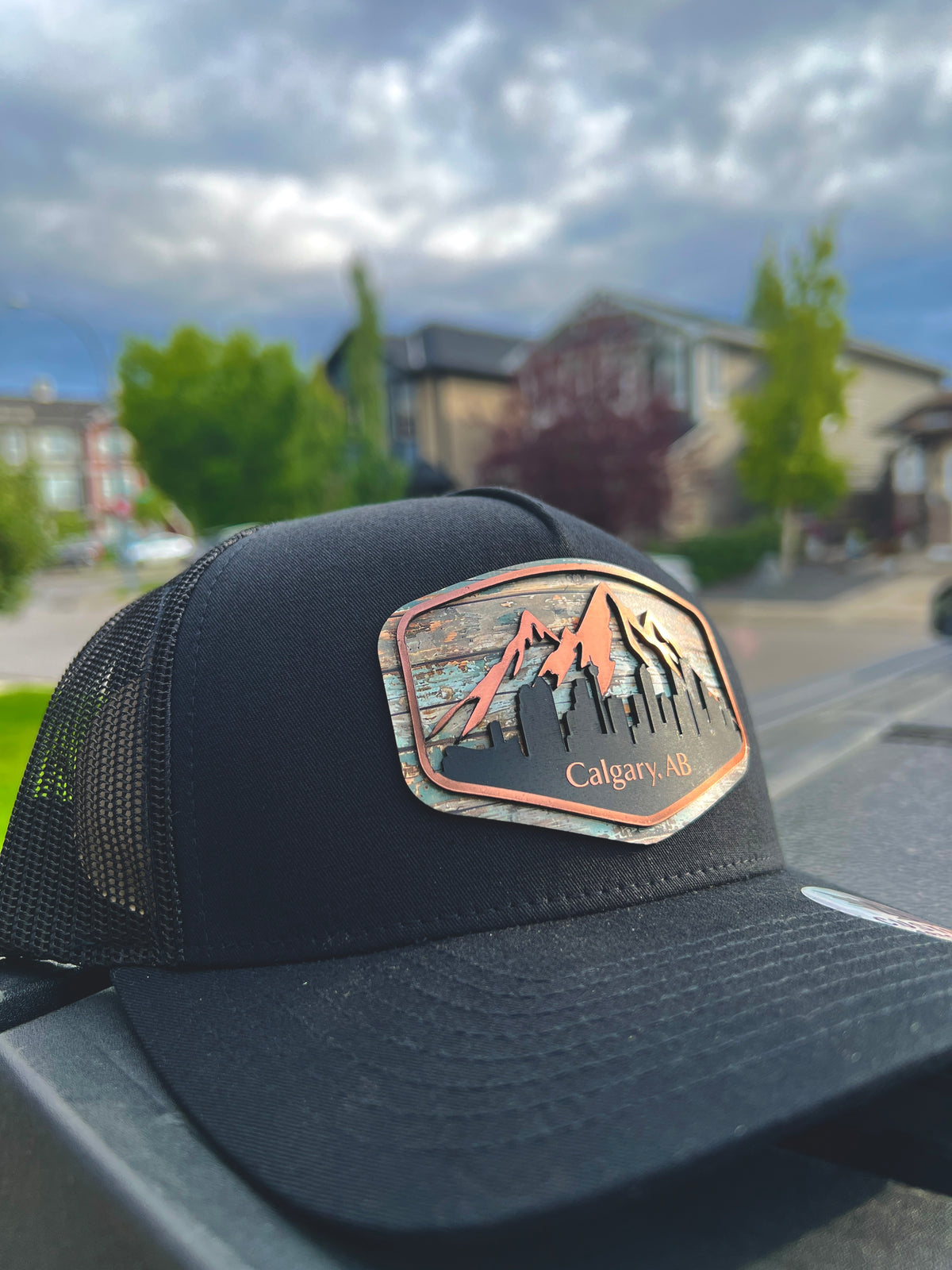 Black Calgary Skyline trucker hat showing the shaped mountain and cityscape patch from a side angle.