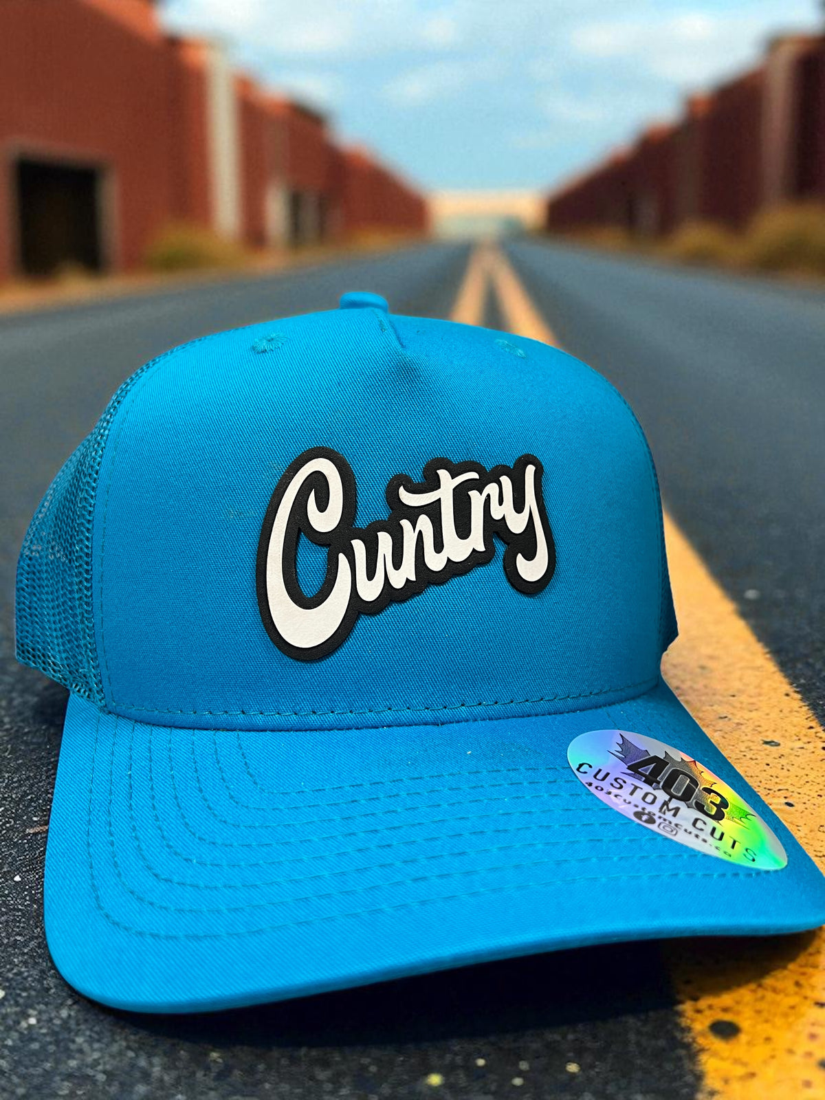 Teal Cuntry snapback trucker hat with a black and white script patch, front view.