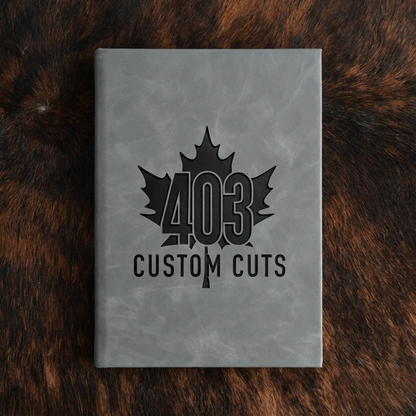 Flint leatherette journal with the engraved 403 Custom Cuts maple leaf logo on the cover.