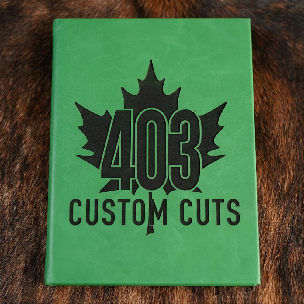 Kelly Green leatherette journal with the engraved 403 Custom Cuts maple leaf logo on the cover.