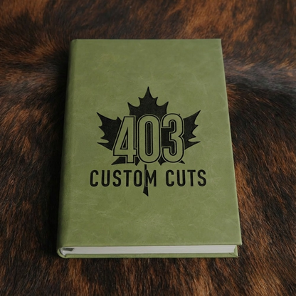 Olive leatherette journal with the engraved 403 Custom Cuts maple leaf logo on the cover.