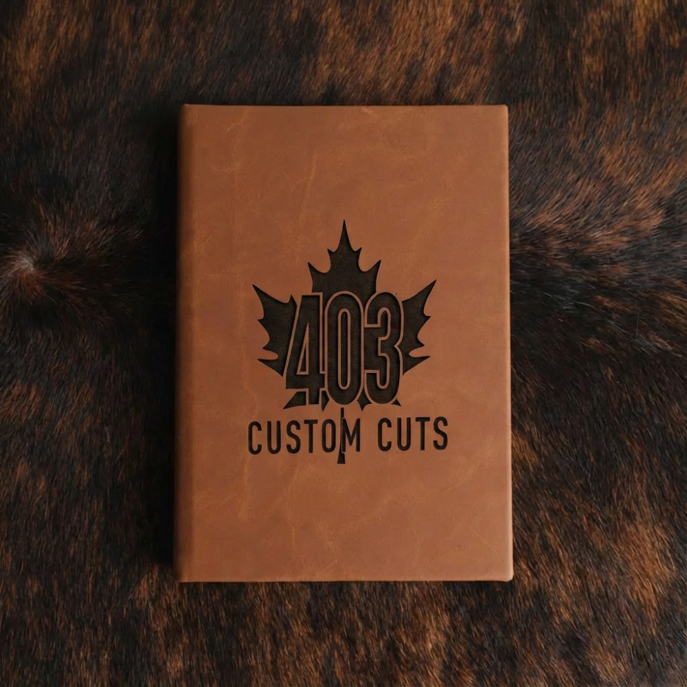 Rawhide leatherette journal with the engraved 403 Custom Cuts maple leaf logo on the cover.