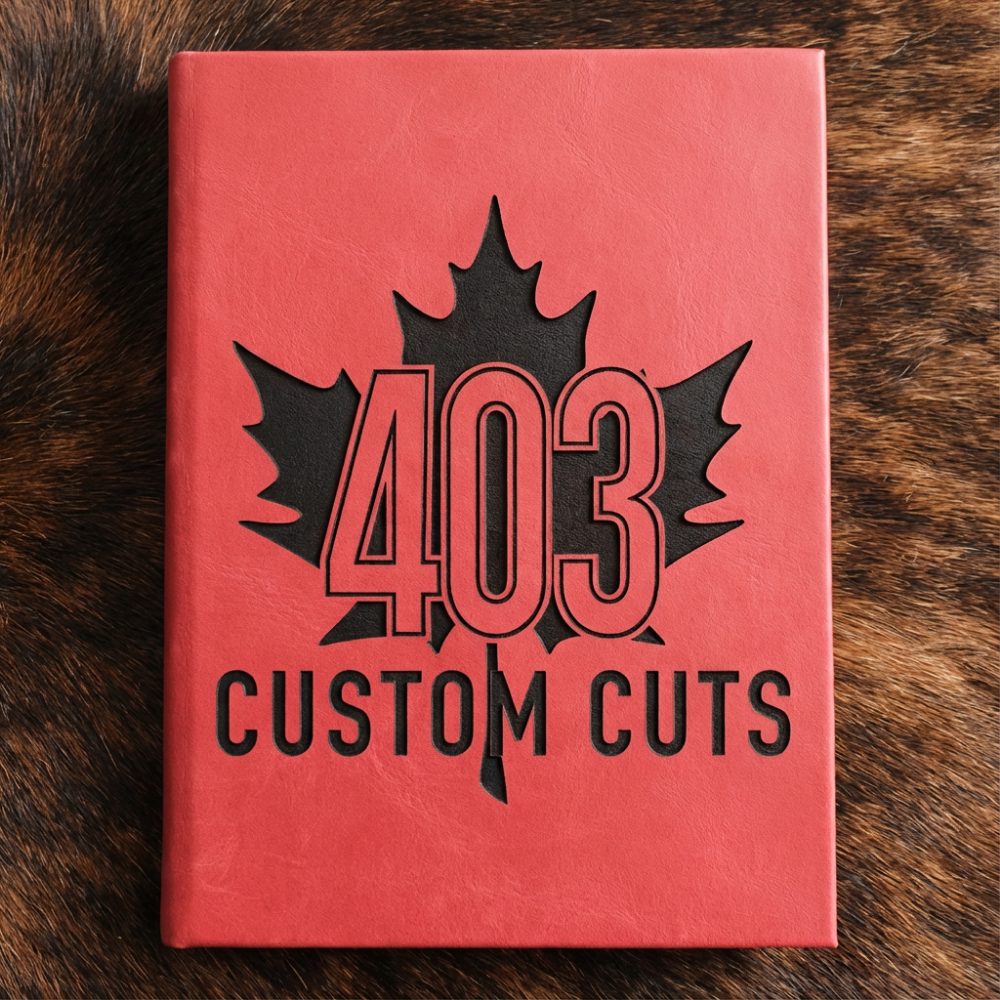 Ruby leatherette journal with the engraved 403 Custom Cuts maple leaf logo on the cover.