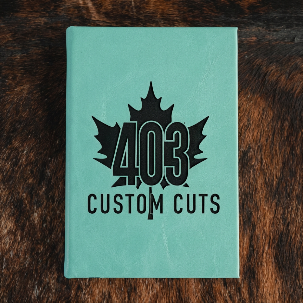 Seafoam Green leatherette journal with the engraved 403 Custom Cuts maple leaf logo on the cover.