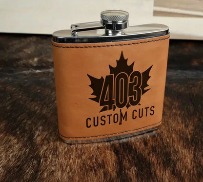 Buckskin leatherette six-ounce flask with a black engraved 403 Custom Cuts logo.