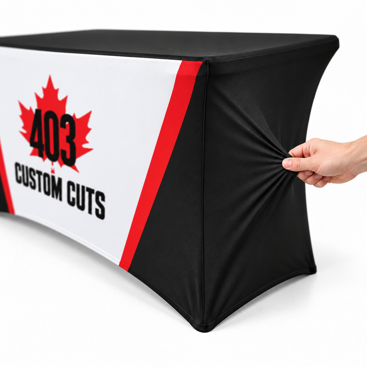 Mockup showing a hand gently stretching the black side fabric of a 403-branded fitted table cover