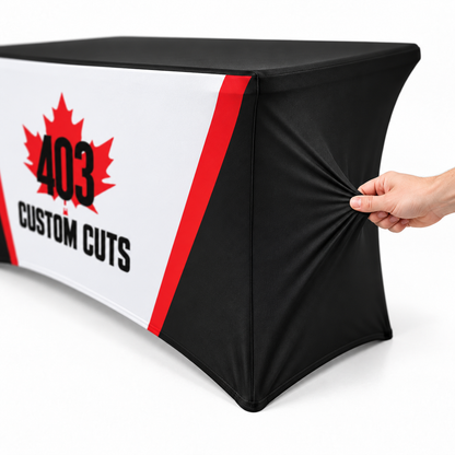 Mockup showing a hand gently stretching the black side fabric of a 403-branded fitted table cover