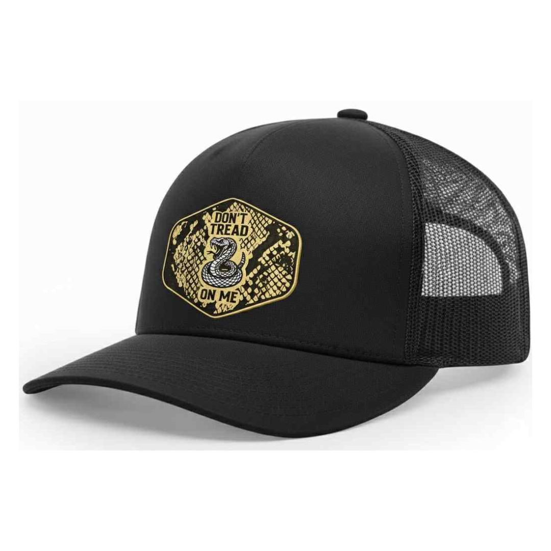Black Don't Tread On Me trucker hat with a metallic snakeskin-pattern coiled snake patch, angled view.