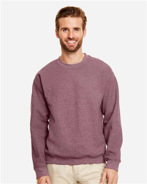 Model wearing a Gildan 18000 Heavy Blend crewneck sweatshirt in Heather Dark Maroon, front view.