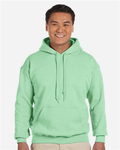 Gildan 18500 Heavy Blend pullover hoodie in Mint Green, front on model view.