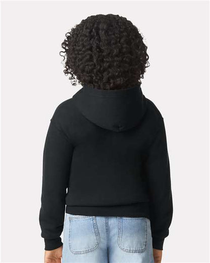 Model wearing a Gildan 18600B Heavy Blend youth full-zip hoodie in Black, back view.