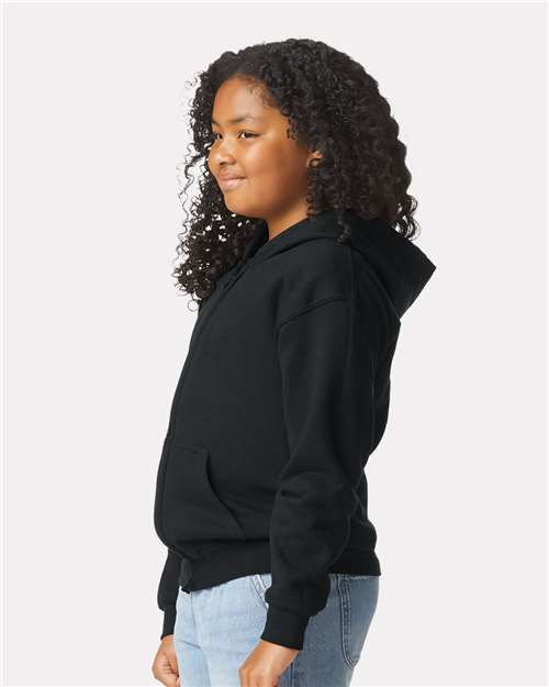 Model wearing a Gildan 18600B Heavy Blend youth full-zip hoodie in Black, side view.