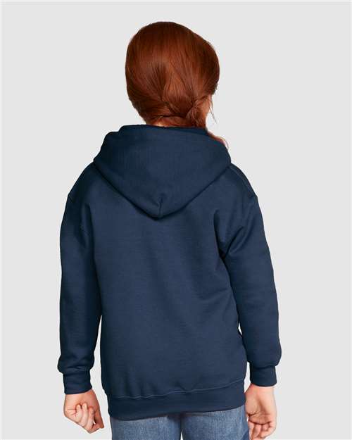 Model wearing a Gildan 18600B Heavy Blend youth full-zip hoodie in Navy, back view.