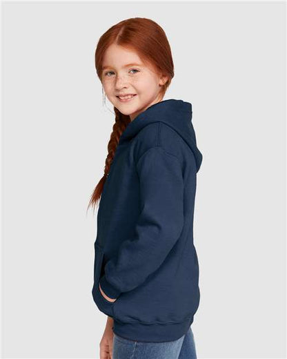 Model wearing a Gildan 18600B Heavy Blend youth full-zip hoodie in Navy, side view.