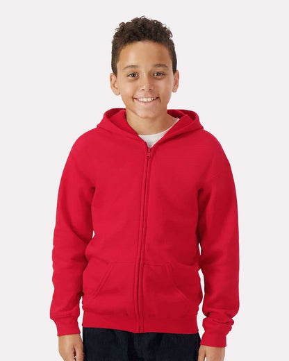 Model wearing a Gildan 18600B Heavy Blend youth full-zip hoodie in Red, front lifestyle view.