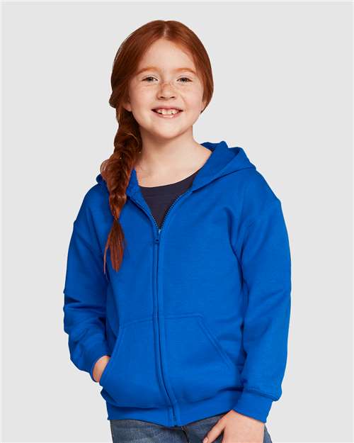 Model wearing a Gildan 18600B Heavy Blend youth full-zip hoodie in Royal, front view.