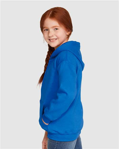 Model wearing a Gildan 18600B Heavy Blend youth full-zip hoodie in Royal, side view.