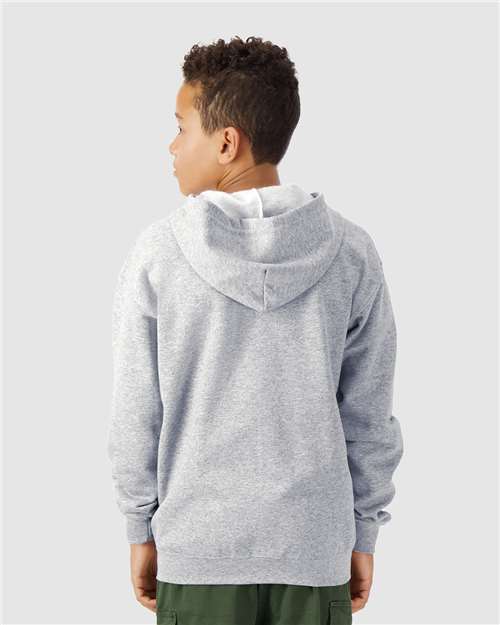 Model wearing a Gildan 18600B Heavy Blend youth full-zip hoodie in Sport Grey, back view.