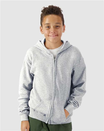 Model wearing a Gildan 18600B Heavy Blend youth full-zip hoodie in Sport Grey, front view.