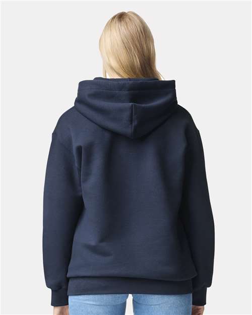 Model wearing a Gildan 19500 Maxweight Blend pullover hoodie in Blue Dusk, back view.