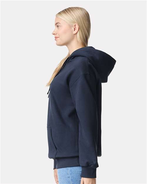 Model wearing a Gildan 19500 Maxweight Blend pullover hoodie in Blue Dusk, side view.