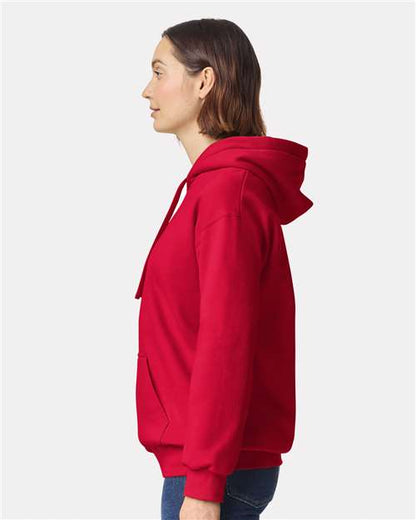 Model wearing a Gildan 19500 Maxweight Blend pullover hoodie in Cherry Red, side view.