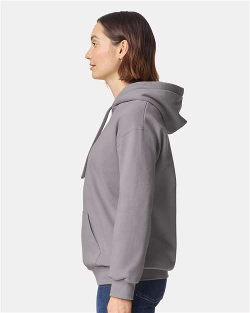Model wearing a Gildan 19500 Maxweight Blend pullover hoodie in Gravel, side view.