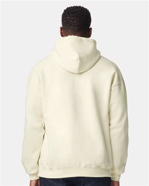 Model wearing a Gildan 19500 Maxweight Blend pullover hoodie in Off White, back view.