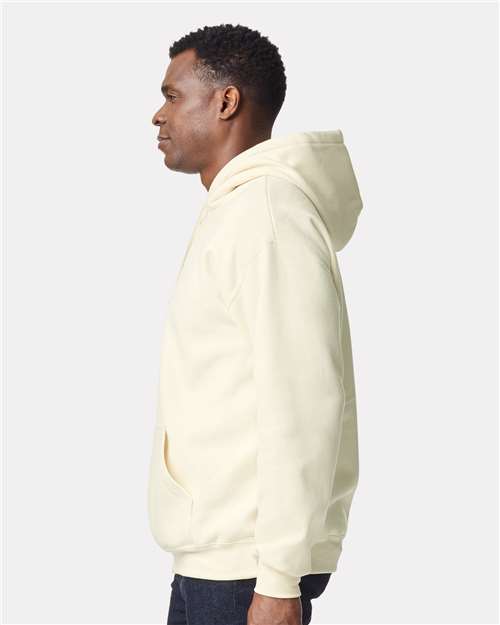 Model wearing a Gildan 19500 Maxweight Blend pullover hoodie in Off White, side view.