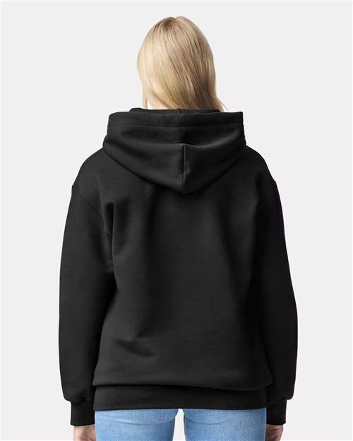 Model wearing a Gildan 19500 Maxweight Blend pullover hoodie in Pitch Black, back view.