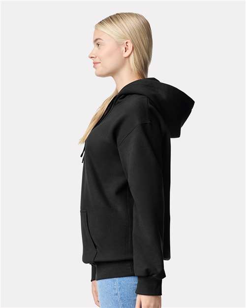 Model wearing a Gildan 19500 Maxweight Blend pullover hoodie in Pitch Black, side view.
