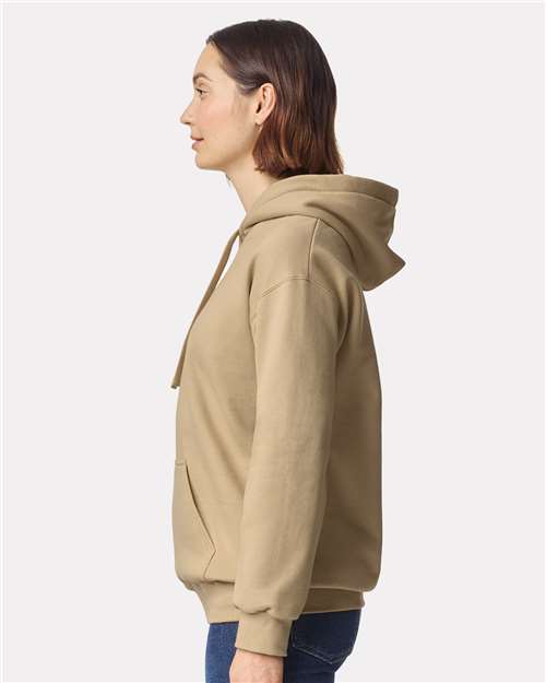 Model wearing a Gildan 19500 Maxweight Blend pullover hoodie in Tan, side view.