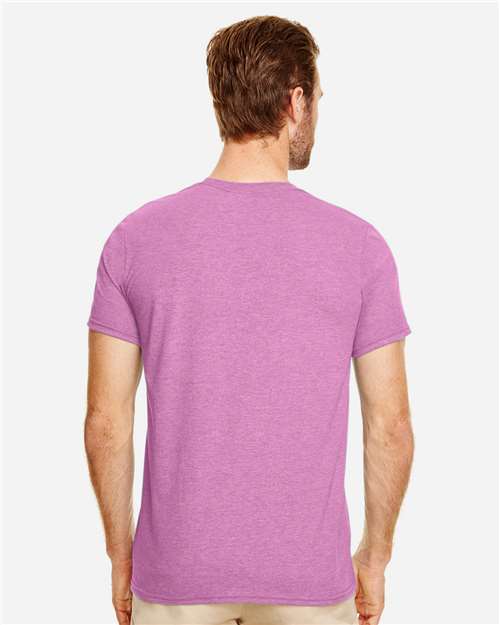 Model wearing a Gildan 64000 Softstyle T-shirt in Heather Radiant Orchid, back view.