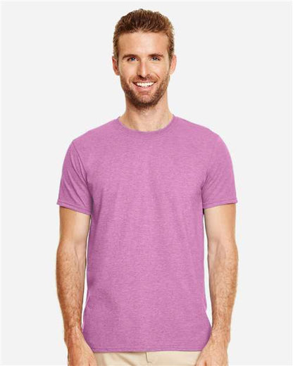 Model wearing a Gildan 64000 Softstyle T-shirt in Heather Radiant Orchid, front view.